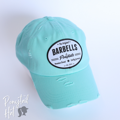 solid light blue ponytail hat with barbells and ponytails text