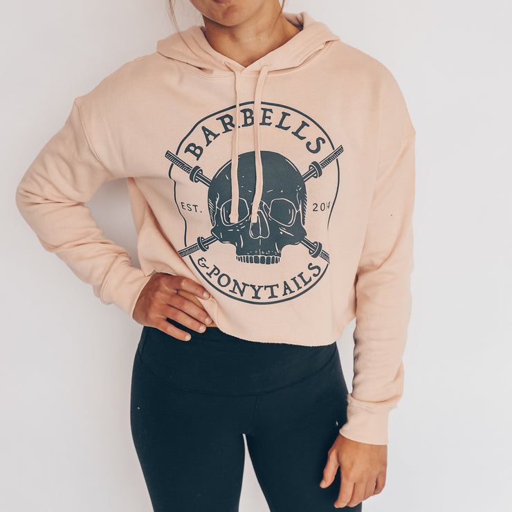blush crop hoodie with grey skulls and barbells design