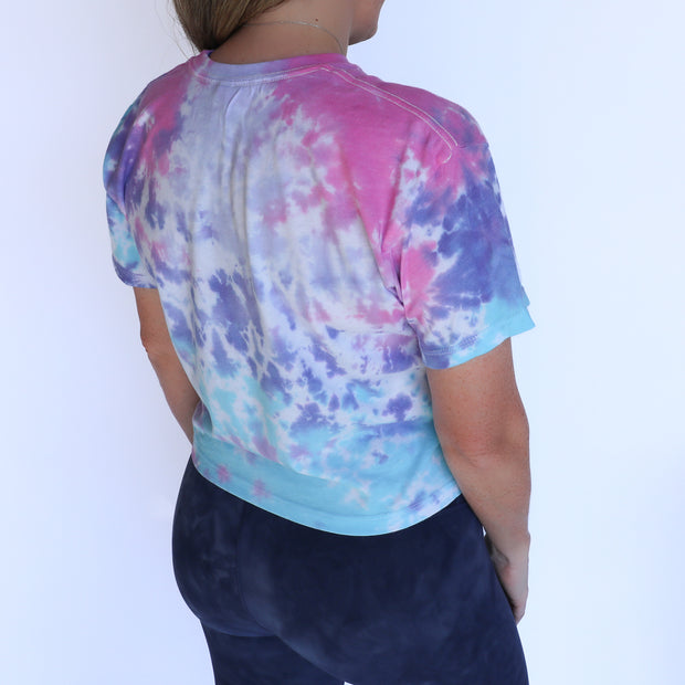 cotton candy tie-dye crop tee with navy barbells and ponytails text