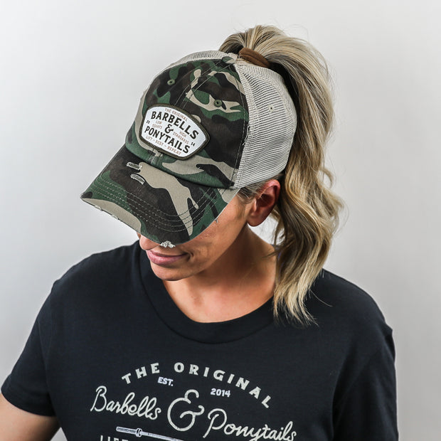 camo mesh ponytail hat with barbells and ponytails text