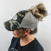 camo mesh ponytail hat with barbells and ponytails text