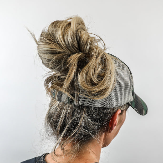 camo mesh ponytail hat with barbells and ponytails text