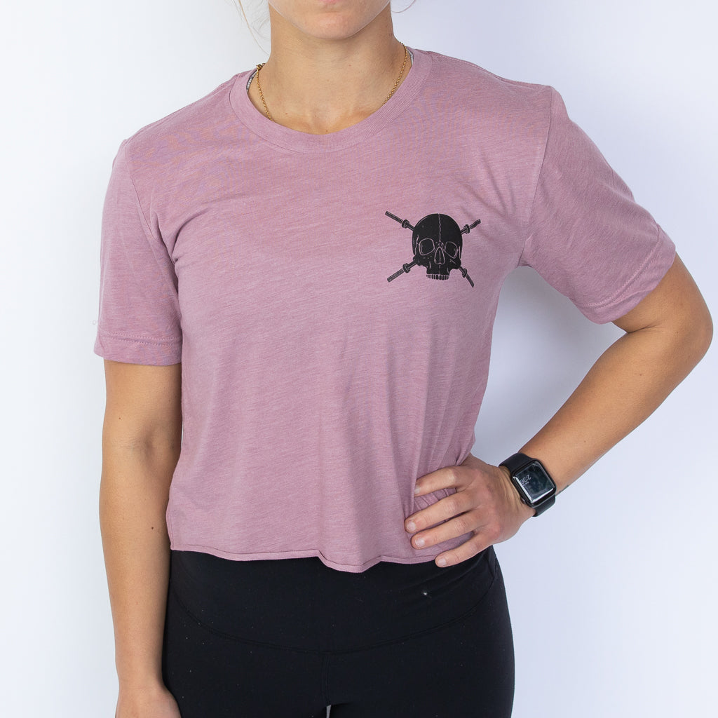 purple crop tee with black skulls and barbells design