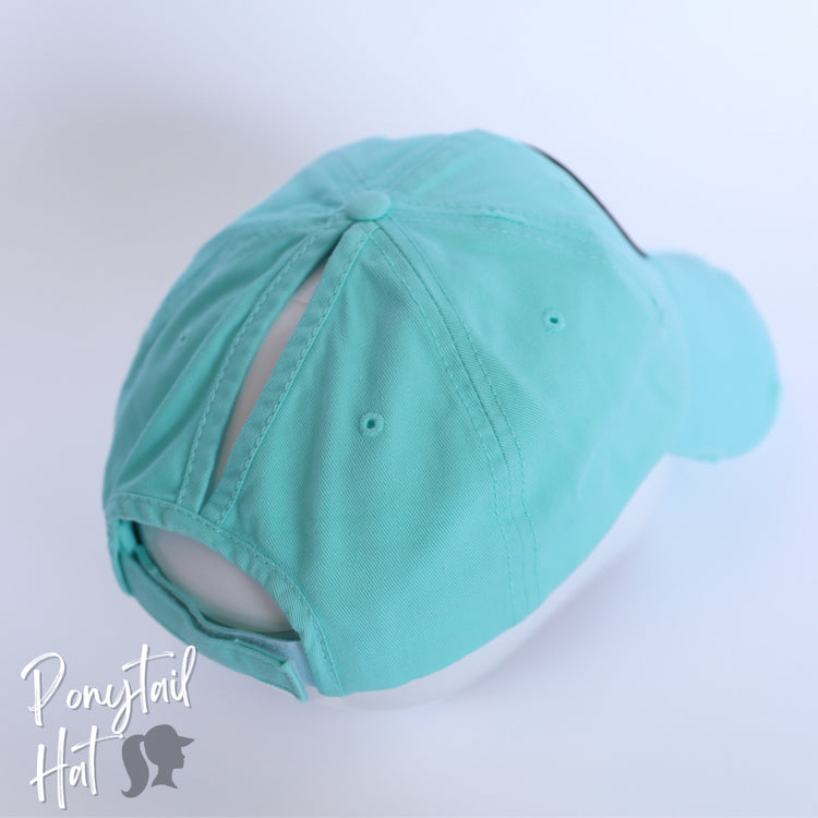 solid light blue ponytail hat with barbells and ponytails text