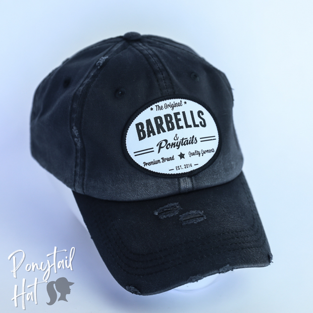 solid black ponytail hat with barbells and ponytails text