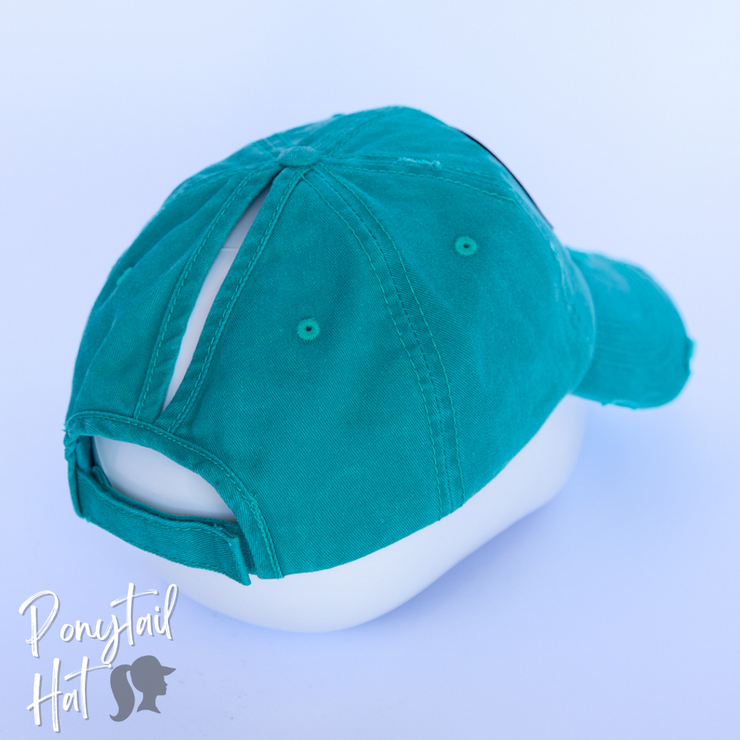 solid aqua ponytail hat with skulls and barbells text