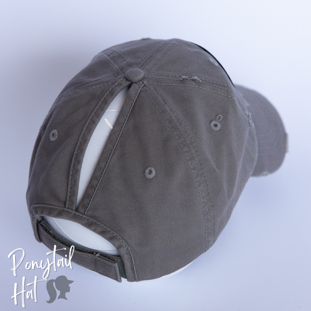solid light grey ponytail hat with barbells and ponytails text
