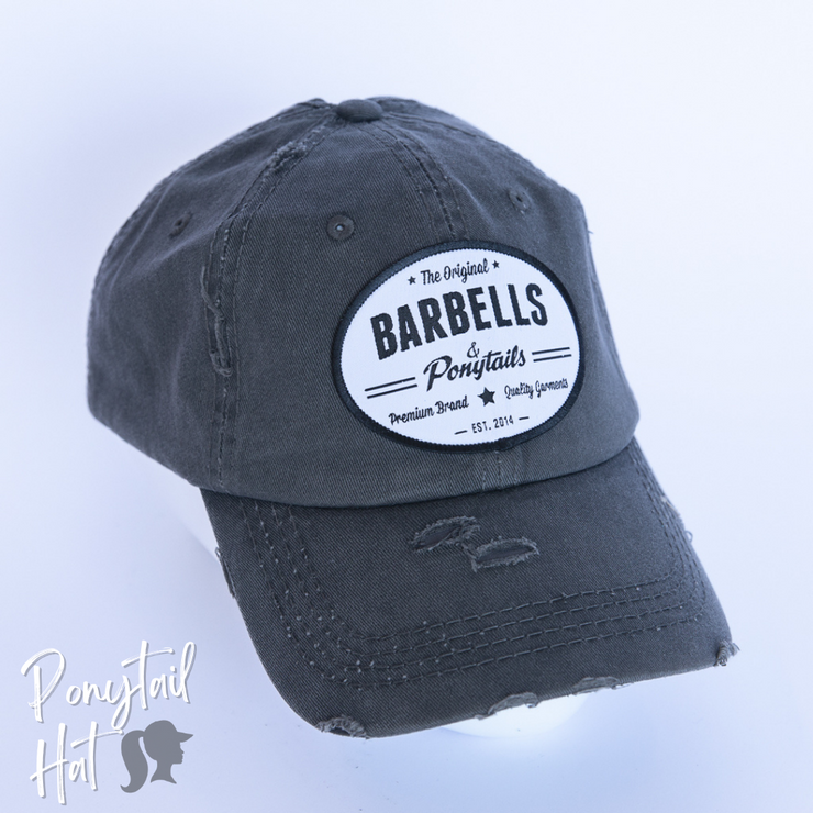 solid dark grey ponytail hat with barbells and ponytails text