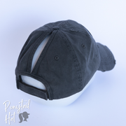 solid dark grey ponytail hat with barbells and ponytails text
