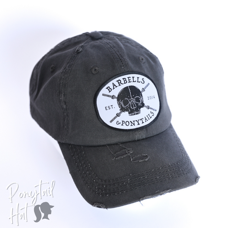 solid dark grey ponytail hat with skulls and barbells text