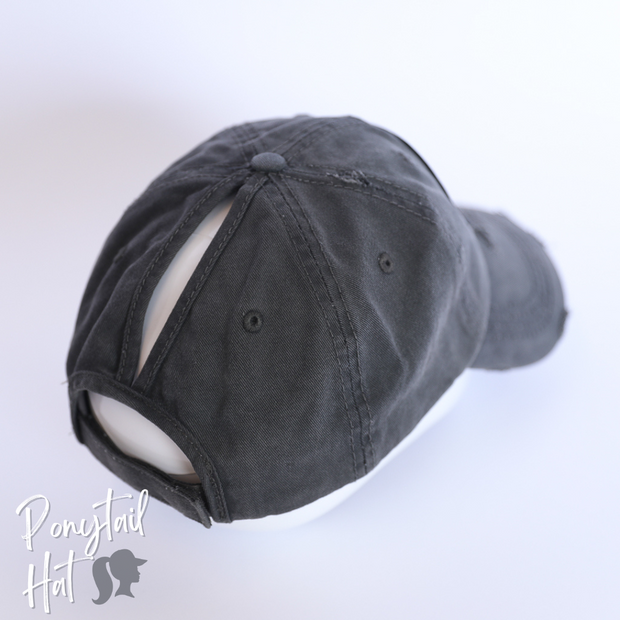 solid dark grey ponytail hat with skulls and barbells text